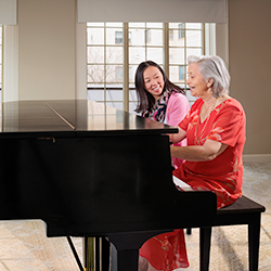 resident and staff playing piano