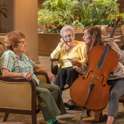 residents and a staff with a cello