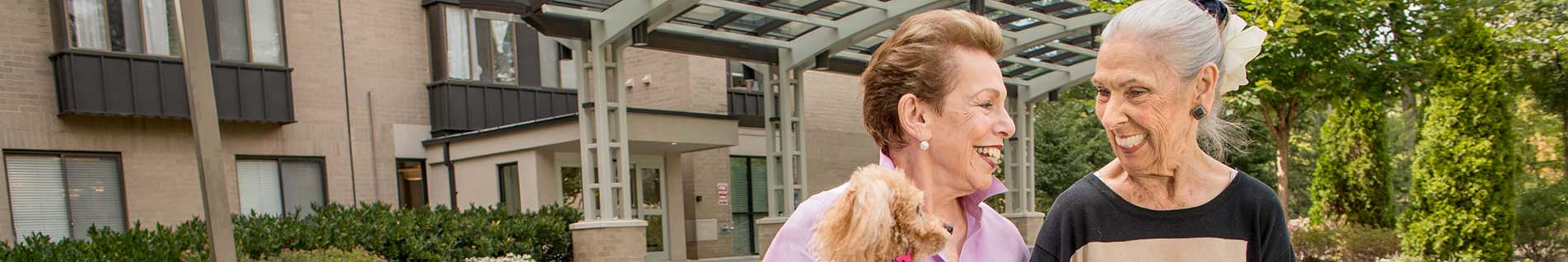 residents walking outside with a dog