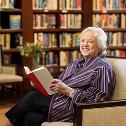 resident reading in a library